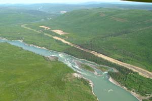 Alaska Highway following river with rapids and landing strip 